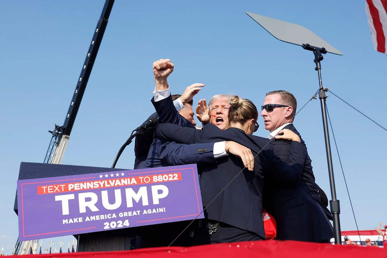 Republican presidential candidate former President Donald Trump is rushed offstage following an assassination attempt at a rally in Butler, Pennsylvania on July 13, 2024. Credit: Anna Moneymaker/Getty Images.