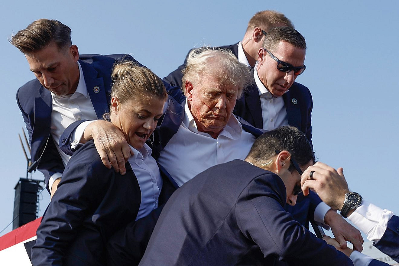 Republican presidential candidate former President Donald Trump is rushed offstage by U.S. Secret Service agents after being grazed by a bullet during a rally in Butler, Pa., on July 13, 2024. Photo by Anna Moneymaker/Getty Images.