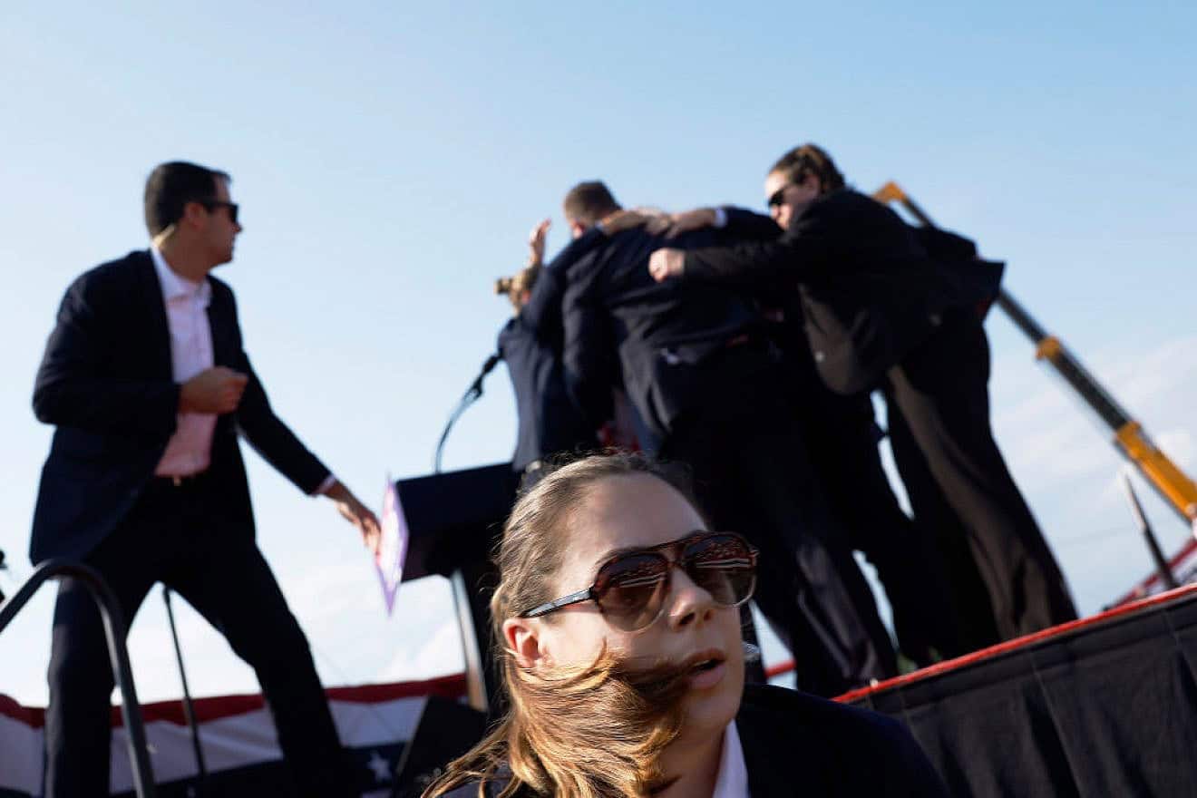 Republican presidential candidate former President Donald Trump is rushed offstage by U.S. Secret Service agents after being grazed by a bullet during a rally in Butler, Pennsylvania on July 13, 2024. Credit: Anna Moneymaker/Getty Images.
