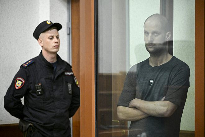 Wall Street Journal reporter Evan Gershkovich, accused of espionage, stands inside a glass defendants' cage during the verdict announcement at the Sverdlovsk Regional Court in Yekaterinburg on July 19, 2024. Photo by Alexander Nemenov/AFP via Getty Images.