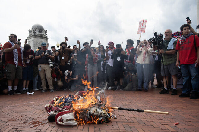 Protesters burn an American flag outside of Union Station in Washington, D.C., following Israeli Prime Minister Benjamin Netanyahu's address during a joint session of Congress on July 24, 2024. Photo by Matthew Hatcher/AFP via Getty Images.
