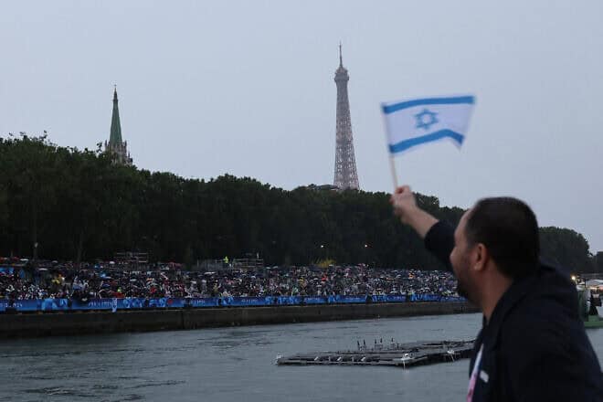 Israeli athletes aboard a boat in the floating parade on the Seine River during the Opening Ceremony of the Olympic Games in Paris, July 26, 2024. Photo by Nir Elias/POOL via Getty Images.
