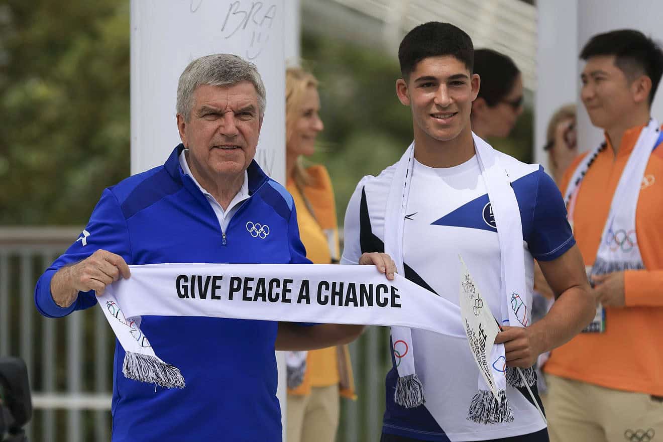 IOC President Thomas Bach and Niv Yehoshua of Team Israel interact during the Athletes' Call for Peace event at the Olympic Village Plaza ahead of the Paris 2024 Olympic Games on July 22, 2024 in Saint-Denis, Paris, France. Photo by Maja Hitij/Getty Images.