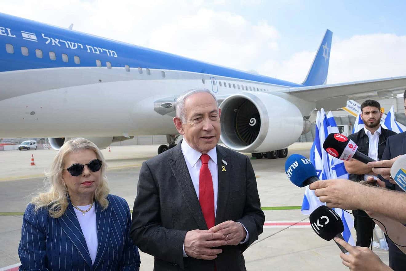 Israeli Prime Minister Benjamin Netanyahu speaks to the press alongside his wife, Sara, before boarding a plane to Washington, D.C., where he addressed Congress and met with President Joe Biden and other officials, July 22, 2024. Photo by Amos Ben Gershom/GPO.
