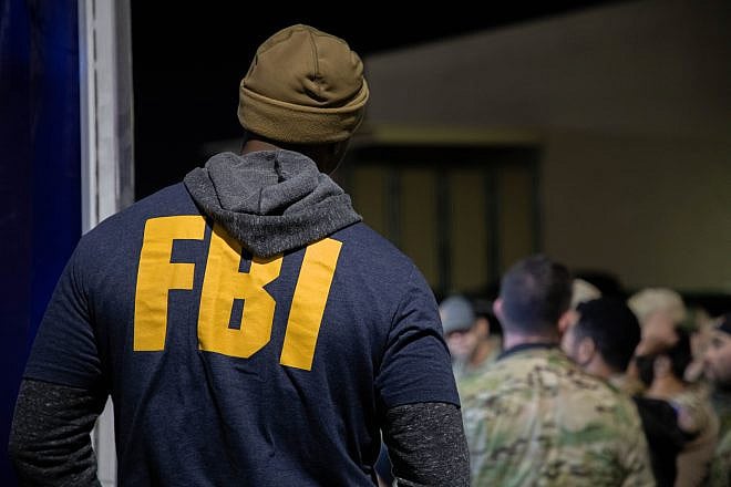 An FBI agent listens to the operation pre-briefing for Operation Dead Hand in Los Angeles on Jan. 30, 2024. Credit: Federal Bureau of Investigation.