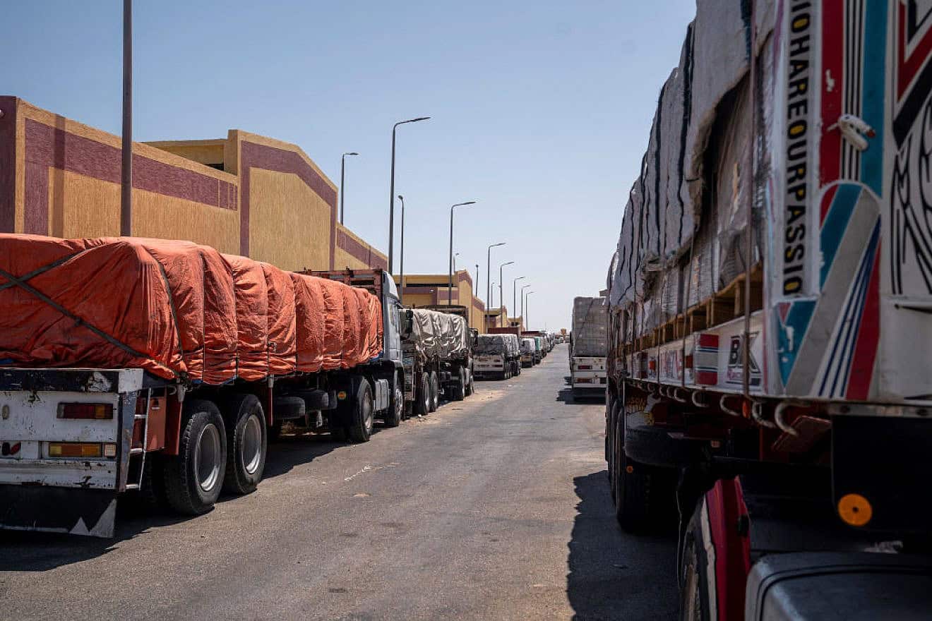Trucks loaded with supplies for Gaza wait in Al-Arish City, North Sinai, because Egypt refuses to allow them to transit the Rafah Crossing as long as Israel controls the Gaza side, July 9, 2024. Photo by Ali Moustafa/Getty Images.