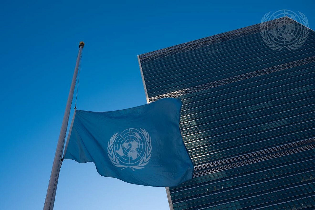 The U.N. flag is lowered to half-mast at the headquarters of the world body in New York City to honor colleagues killed in the Gaza Strip, Nov. 13, 2023. Credit: Evan Schneider/U.N. Photo.