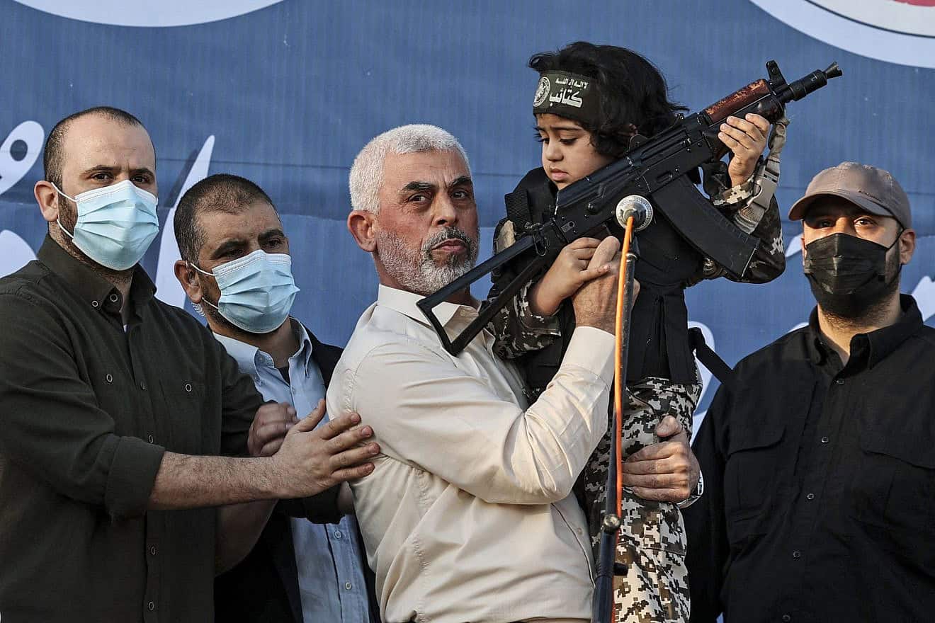 Hamas leader Yahya Sinwar holds the son of an Al-Qassam Brigades terrorist who was killed in recent fighting with Israel, during a rally in Gaza City, May 24, 2021. Photo by Mahmud Hams/AFP via Getty Images.