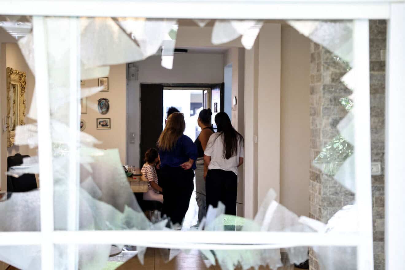 Residents check damage caused by a rocket fired by Hezbollah from Lebanon in a home in Acre, north of Haifa, on Aug. 25, 2024. Photo by Jack Guez/AFP via Getty Images.