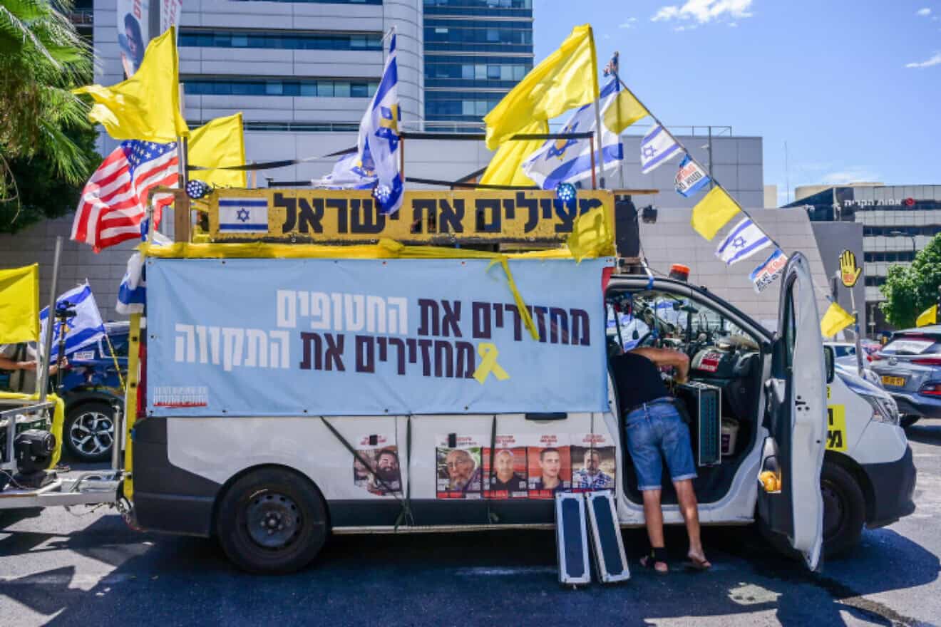Relatives and supporters of Israelis held hostage by Hamas terrorists in Gaza prepare to leave in a convoy from Tel Aviv toward the Gaza Strip, Aug. 28, 2024. Photo by Avshalom Sassoni/Flash90.