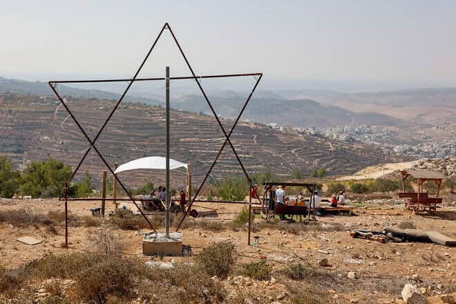 Israelis celebrate Sukkot on the outskirts of Neve Daniel in Gush Etzion, Oct. 11, 2022. Photo by Gershon Elinson/Flash90.