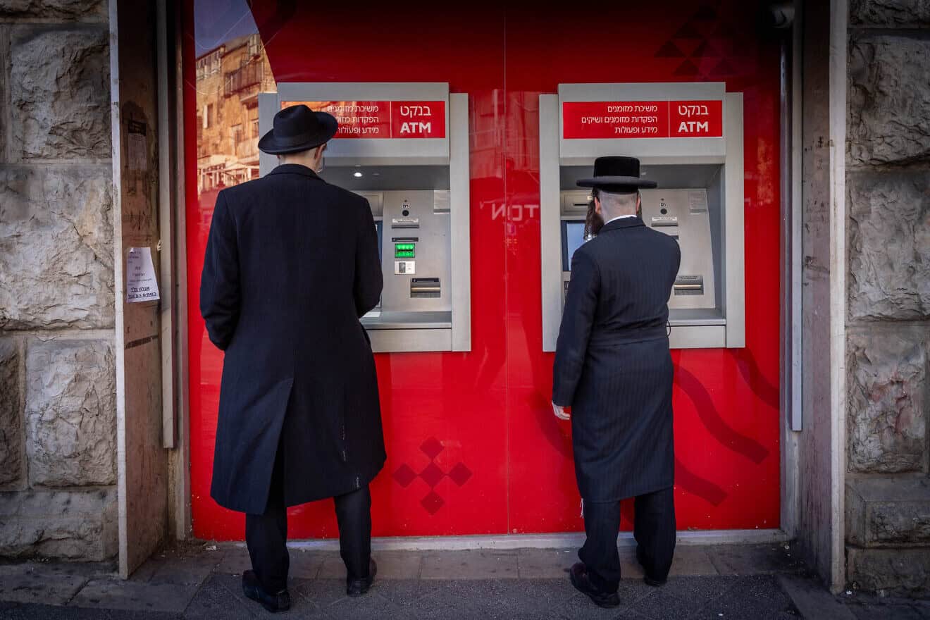 Men at ATM machines in the haredi neighborhood of Mea Shearim in Jerusalem, Feb. 5, 2024. Photo by Chaim Goldberg/Flash90.