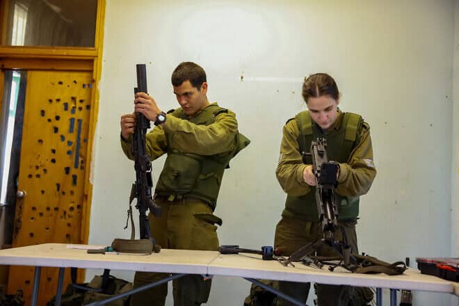Israel Defense Forces troops clean their weapons ahead of a training session near the country's northern border with Lebanon, Jan. 16, 2024. Photo by David Cohen/Flash90.