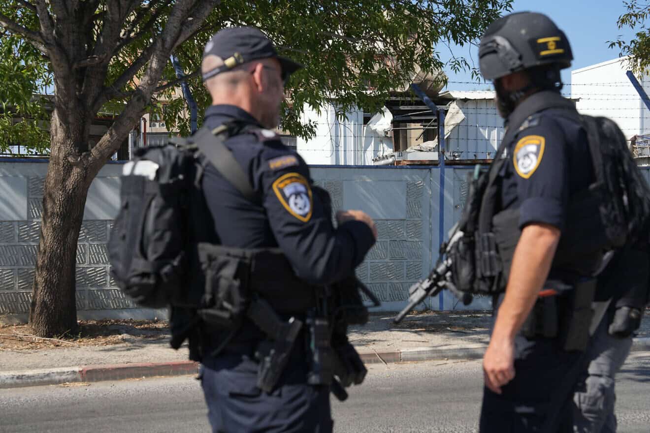 Israel Police officers at a factory in Kiryat Shmona after a Lebanese missile hit there, Aug. 4, 2024. Photo by Ayal Margolin/Flash90.