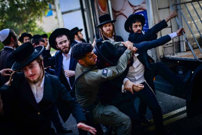 Ultra-Orthodox men clash with police during a protest against the military draft outside the Israel Defense Forces' Meitav Reception and Sorting Base at Tel Hashomer in Ramat Gan, Aug. 5, 2024. Photo by Tomer Neuberg/Flash90.