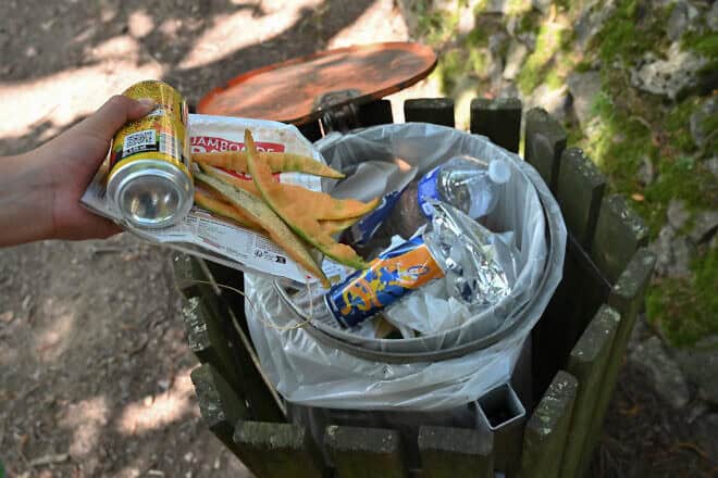 Food waste and melon skins into a public garbage can, Aug. 3, 2024. Photo by MATTHIEU DELATY/Hans Lucas/AFP via Getty Images.