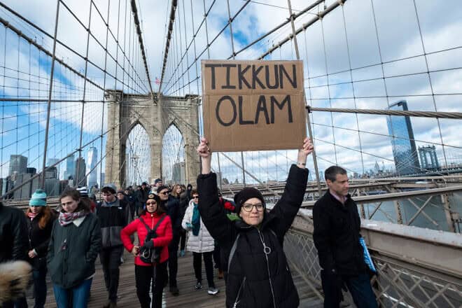 A marcher walking across the Brooklyn Bridge in support of the No Hate No Fear Jewish Solidarity March on Jan. 1, 2020. Photo by Ira L. Black/Corbis via Getty Images.