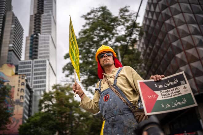 A protester holds a sign in support of a Palestinian state during a rally in Bogota on International Workers Day, May 1, 2024. Photo by Diego Cuevas/Getty Images.