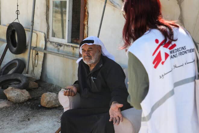 A Doctors Without Borders (MSF) charity coordinator speaks with a Palestinian in Susya village in Judea on July 17, 2024. Photo by Mosab Shawer/AFP via Getty Images.