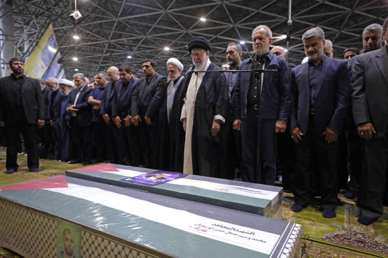 In this handout image from the Office of the Iranian Supreme Leader, Supreme Leader Ayatollah Ali Khamenei, center, leads a prayer over the coffins of Hamas leader Ismail Haniyeh and his bodyguard at Tehran University on Aug. 1, 2024. Credit Office of the Iranian Supreme Leader via Getty Images.