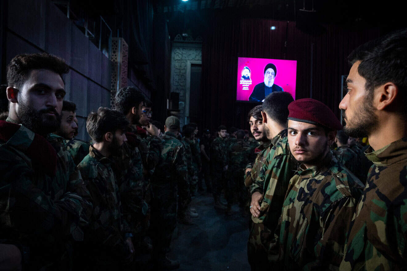 Lebanese terrorists watch as Hezbollah leader Hassan Nasrallah speaks via video link at the funeral of his No. 2, Fuad Shukr, in Beirut, Aug. 1, 2024. Photo by Oliver Marsden/Middle East Images/AFP via Getty Images.