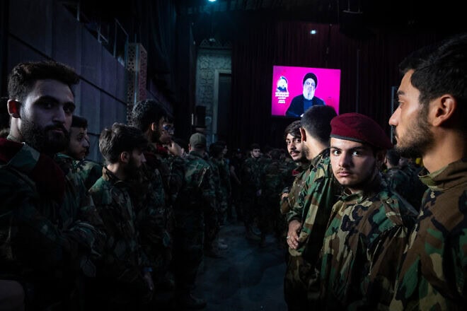 Lebanese terrorists watch as Hezbollah leader Hassan Nasrallah speaks via video link at the funeral of his No. 2, Fuad Shukr, in Beirut, Aug. 1, 2024. Photo by Oliver Marsden/Middle East Images/AFP via Getty Images.