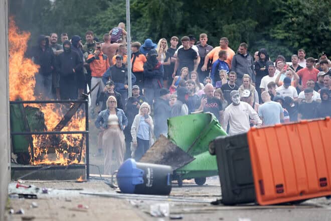 Anti-immigration protesters are seen during riots outside of the Holiday Inn Express in Manvers, which is being used as an asylum hotel, on Aug. 4, 2024 in Rotherham, United Kingdom. Photo by Christopher Furlong/Getty Images.