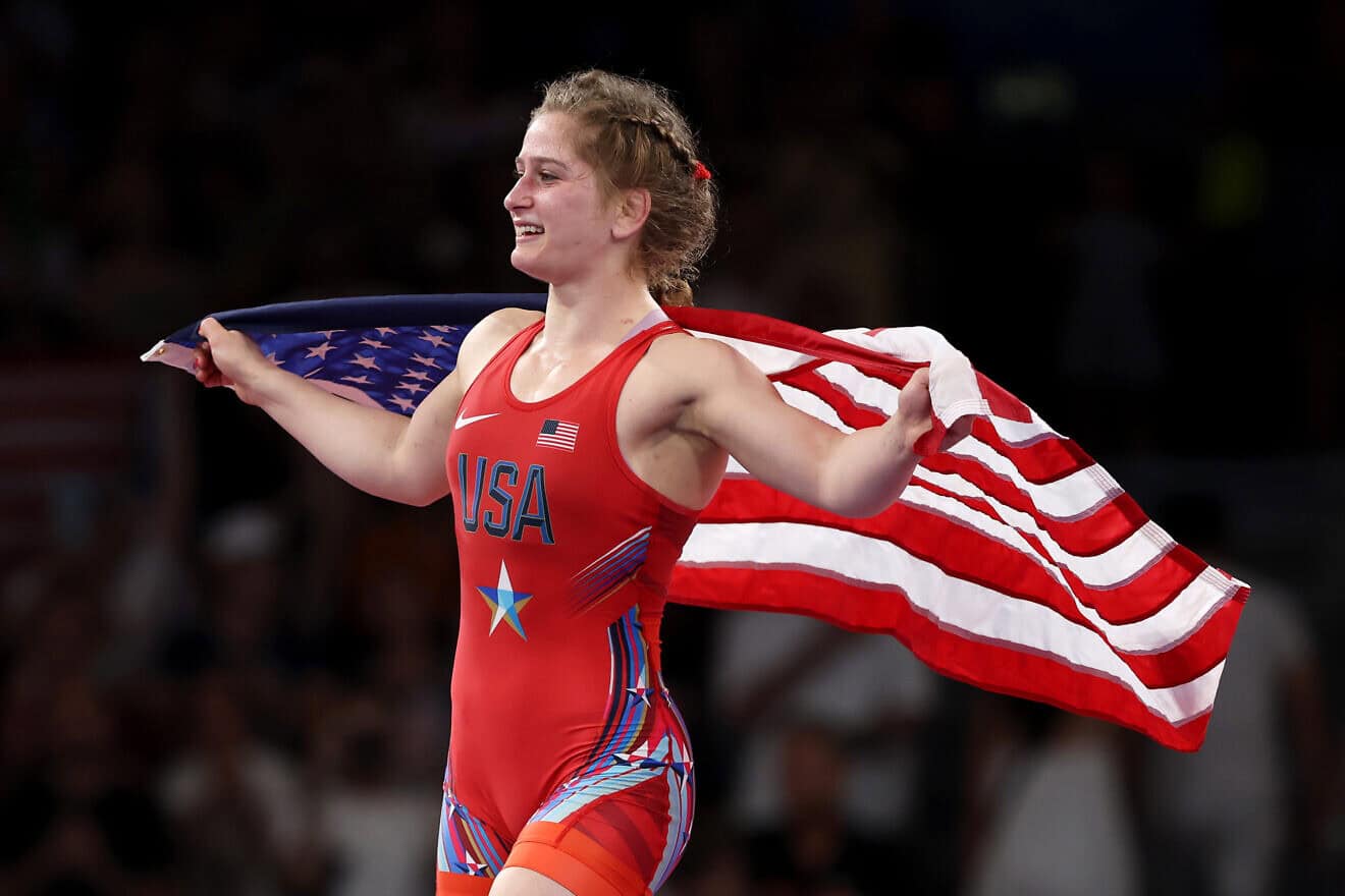 Amit Elor of Team United States celebrates with the United States flag following victory against Meerim Zhumanazarova of Team Kyrgyzstan (not pictured) during the Wrestling Women's Freestyle 68kg Gold Medal match on day eleven of the Olympic Games Paris 2024 at Champs-de-Mars Arena on Aug. 6, 2024 in Paris, France. Photo by Sarah Stier/Getty Images.
