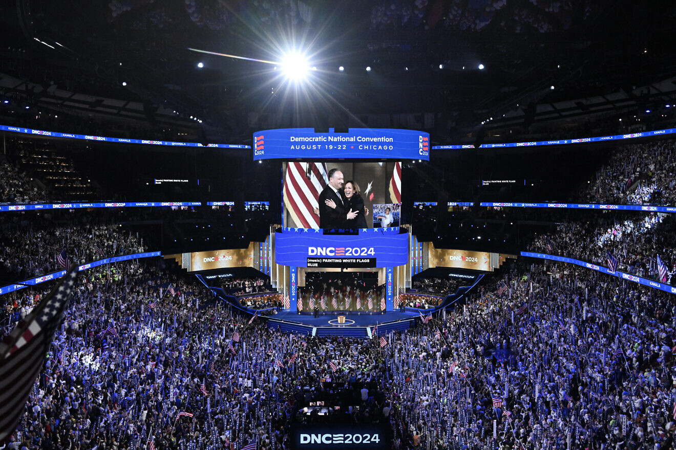 U.S. Vice President and Democratic presidential candidate Kamala Harris hugs her husband, second gentleman Doug Emhoff, as she concludes her remarks at the end of the fourth and last day of the Democratic National Convention at the United Center in Chicago, on Aug. 22, 2024. Photo by Mandel NGAN/AFP via Getty Images.