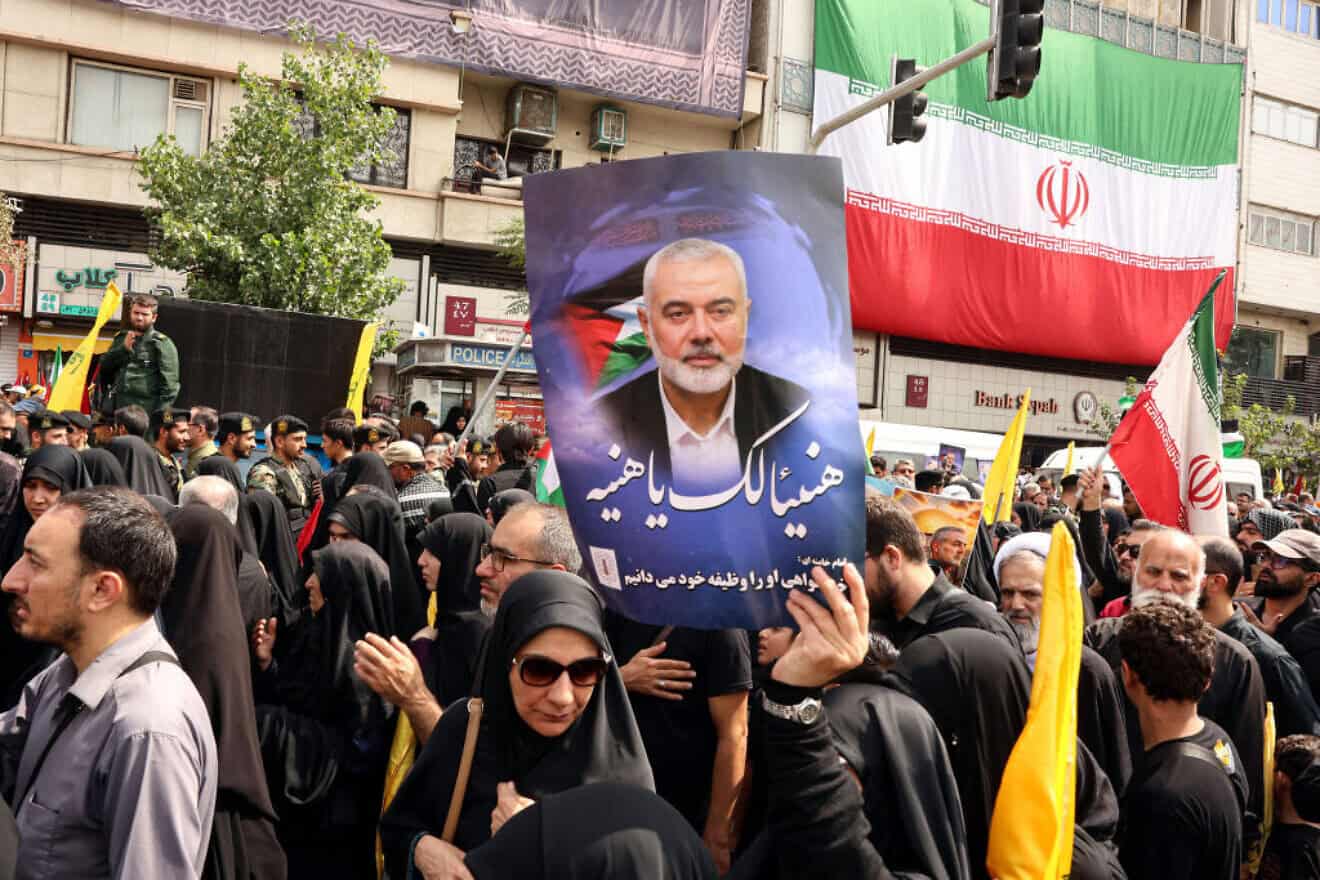 Iranians hold portraits of Hamas leader Ismail Haniyeh during his funeral procession in Tehran ahead of his burial in Qatar, Aug. 1, 2024. Photo by AFP via Getty Images.