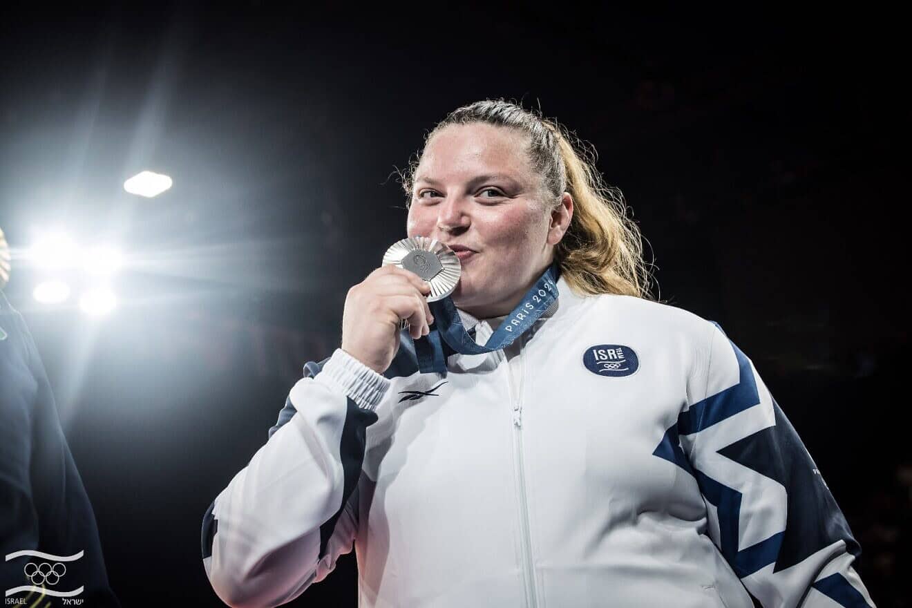 Israeli judoka Raz Hershko kisses her silver medal at the Paris Olympics, Aug. 2, 2024. Credit: Olympic Committee of Israel.