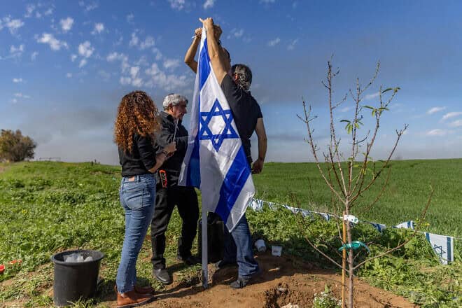 Friends and family of Liraz Assulin, who was murdered by Hamas terrorists in in southern Israel on Oct. 7, plant a tree in her memory near the Israeli border with the Gaza Strip, Jan. 21, 2024. Photo by Chaim Goldberg/Flash90.