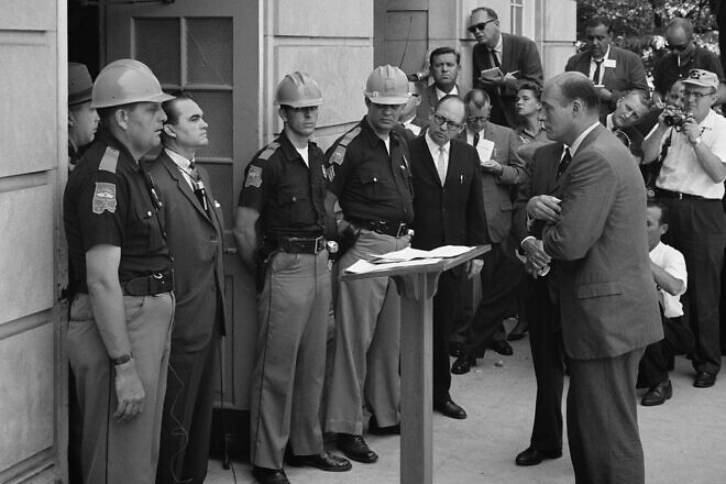 Attempting to block integration at the University of Alabama on June 11, 1963, Gov. George Wallace stands defiantly at the door while being confronted by Deputy U.S. Attorney General Nicholas Katzenbach. Credit: Warren K. Leffler/Library of Congress via Wikimedia Commons.