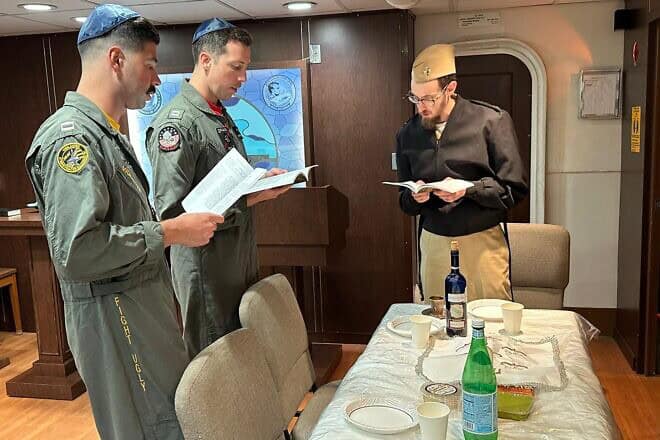 Two Jewish fighter pilots recite Kiddush and hold Shabbat services aboard the USS Abraham Lincoln. Credit: Courtesy of Aleph Institute.