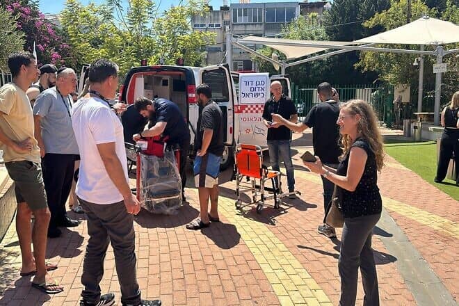 Students gather in front of a Magen David Adom ambulance during the Afeka College of Engineering hackathon which was held in cooperation with the life-saving emergency organization. Credit: Courtesy.