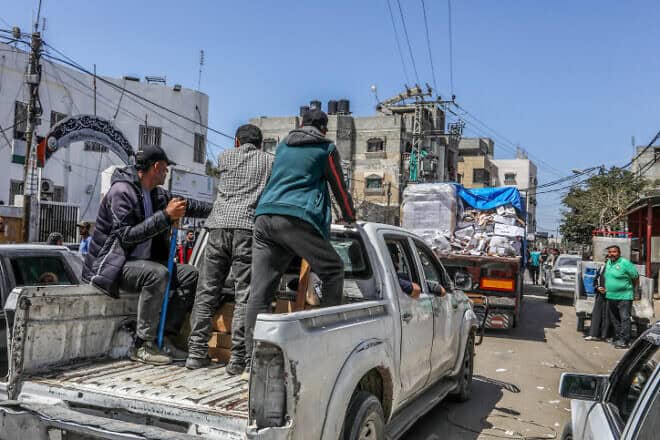 Armed and masked Palestinians on trucks loaded with humanitarian aid entering southern Gaza through the Kerem Shalom Crossing from Israel, April 3, 2024. Photo by Abed Rahim Khatib/Flash90.