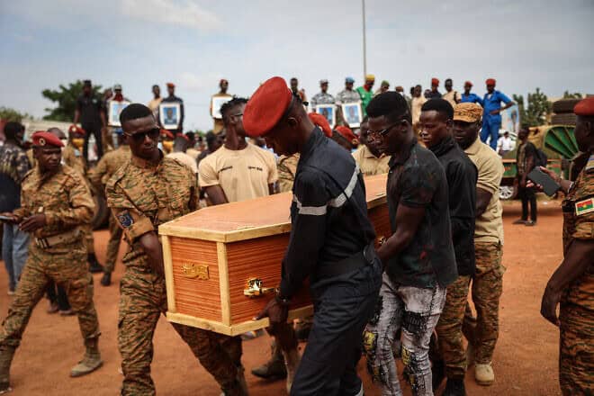 Burkina Faso's servicemen carry a coffin during the burial of the soldiers killed in Gaskinde, in Ouagadougou on Oct. 8, 2022. The ambush in Gaskinde, claimed by Al-Qaeda, officially killed 37 people, including 27 soldiers on Sept. 26, 2022. Photo by Oympia De Miasmont/AFP via Getty Images.