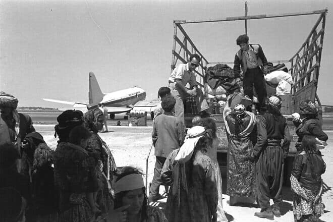 Luggage is put on trucks to take immigrants from Iraq to a transit camp at Lod Airport on May 1, 1951. Credit: National Photo Collection, GPO.il