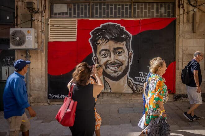 People in central Jerusalem pass a mural of Israeli-American Hersh Goldberg-Polin, 23, who was killed by Hamas in the Gaza Strip after being held hostage since the Oct. 7 terrorist attacks in southern Israel, Sept. 16, 2024. Photo by Chaim Goldberg/Flash90.