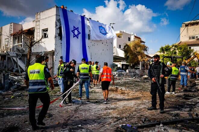 A giant Israeli flag covers the hole left by a rocket that terrorists from Lebanon fired at Kiryat Bialik, Israel, on Sept. 22, 2024. Photo by Chaim Goldberg/Flash90
