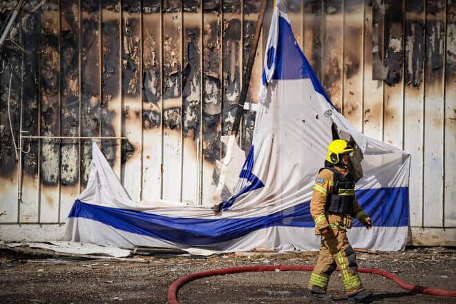 Firefighters at the site of warehouses destroyed in a Hezbollah missile attack, Kiryat Shmona, Sept. 24, 2024. Photo by Ayal Margolin/Flash90.