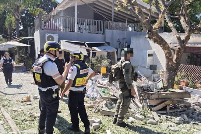 Emergency medical personnel and soldiers inspect the scene of a Hezbollah rocket strike in Kibbutz Sa'ar in northern Israel on Sept. 25, 2024. Credit: MDA.