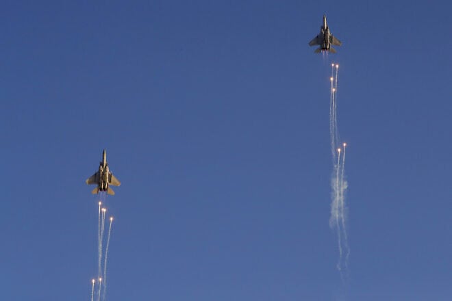 An Israeli F-15 I fighter jet launches anti-missile flares during an air show at the graduation ceremony of Israeli Air Force pilots at the Hatzerim base in the Negev desert, near the southern Israeli city of Beersheva, on June 27, 2019. Photo by Jack Guez/AFP via Getty Images.
