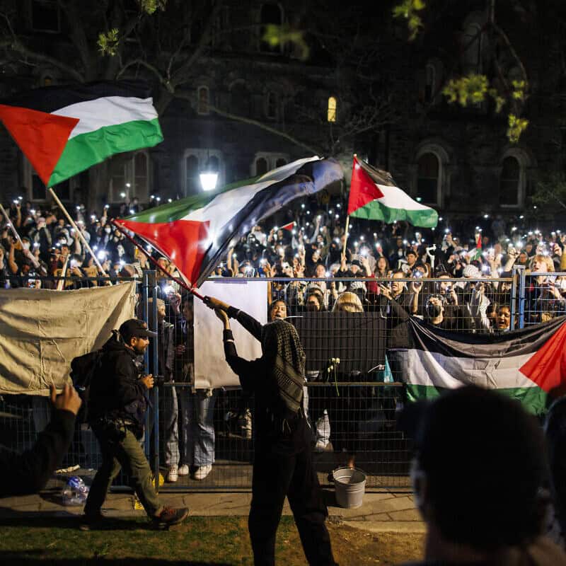 Pro-Palestinian demonstrators outside the fenced in area of an encampment on the University of Toronto campus in Canada on May 2, 2024. Photo by Cole Burston/AFP via Getty Images.