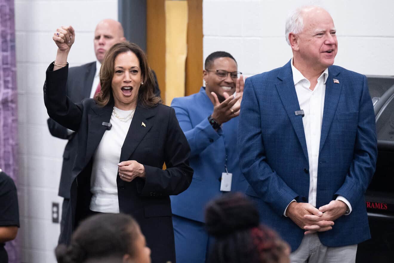 Democratic presidential candidate U.S. Vice President Kamala Harris and her running mate, Gov. Tim Walz, enjoy music by members of the marching band at Liberty County High School in Hinesville, Georgia, Aug. 28, 2024, as they travel across Georgia for a two-day campaign bus tour. Photo by Saul Loeb/AFP via Getty Images.