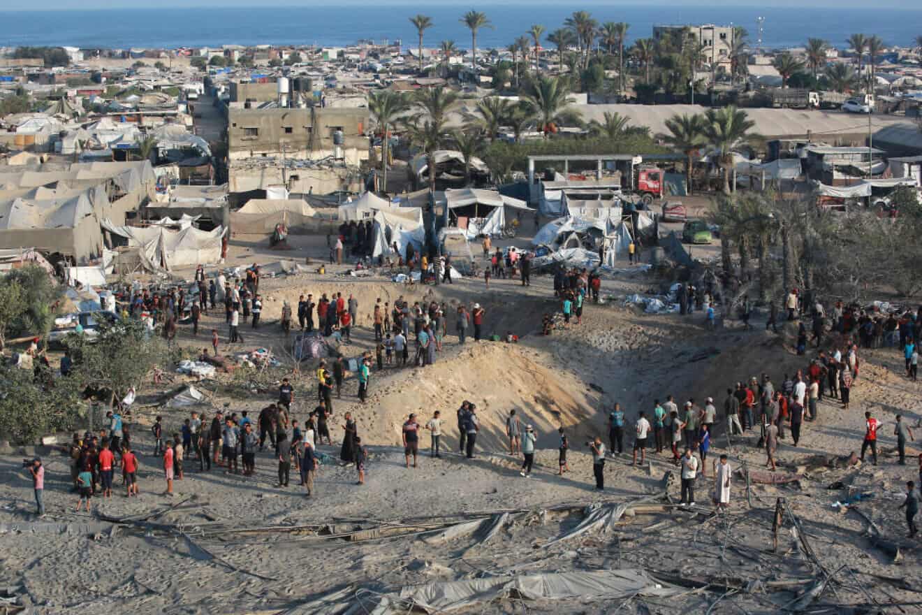 Palestinians inspect the damage at the site of Israeli airstrikes on a makeshift displacement camp in Mawasi Khan Yunis in the Gaza Strip on Sept. 10, 2024. Photo by Bashar Taleb/AFP via Getty Images.