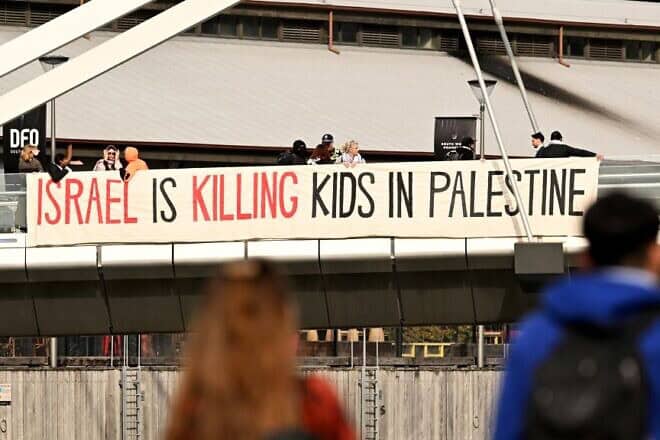 Protesters unfurl a banner outside the Land Forces 2024 arms fair in Melbourne on Sept. 11, 2024. Photo by William West/AFP via Getty Images.