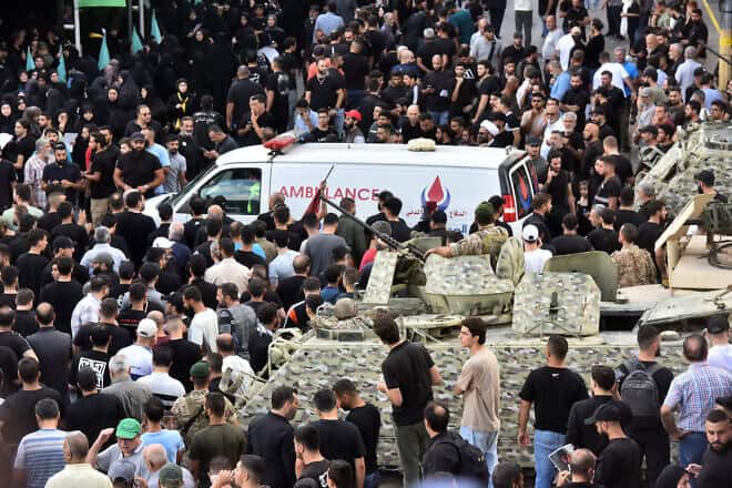Lebanese soldiers stand guard as an ambulance arrives, after a Hezbollah communication device exploded during a funeral for the casualties of a wave of such blasts the previous day targeting the terrorist group, in Beirut's southern suburbs on Sept. 18, 2024. Photo by Fadel Itani/AFP via Getty Images.
