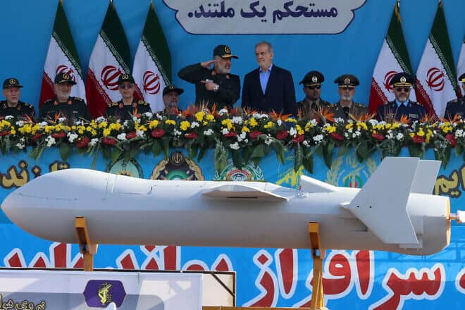 Iranian President Masoud Pezeshkian (R) and commander of the Islamic Revolutionary Guard Corps' Aerospace Force Amir Ali Hajizadeh look on as Iran's new Shahed 136-B drone is displayed during the annual military parade marking the anniversary of the outbreak of the 1980-1988 war with Saddam Hussein's Iraq, in Tehran on Sept. 21, 2024. Photo by Atta Kenare/ AFP via Getty Images.