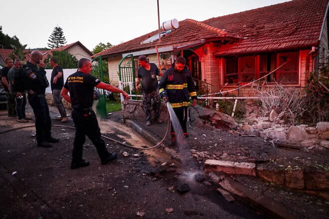 Israeli security forces, firefighters and civilians at the site where a missile fired by Hezbollah in Lebanon hit a house in Rosh Pina, in northern Israel, on Sept. 26, 2024. Photo by David Cohen/Flash90.